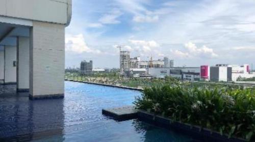 a body of water with a city in the background at Smart Studio - BResidences ICE BSD in Cilandak