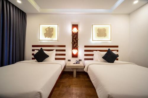 Ένα ή περισσότερα κρεβάτια σε δωμάτιο στο Angkor Breeze Hotel & Spa