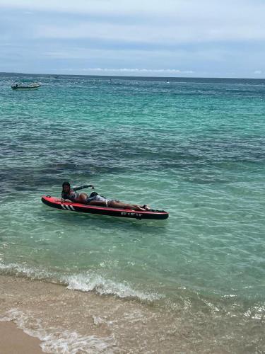 a person laying on a raft in the ocean at Itaca Eco House in Playa Blanca