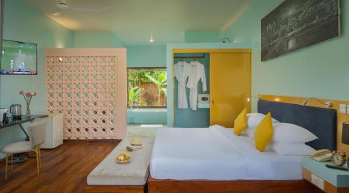 a bedroom with a large white bed and a desk at Sala Siem Reap Resort in Siem Reap