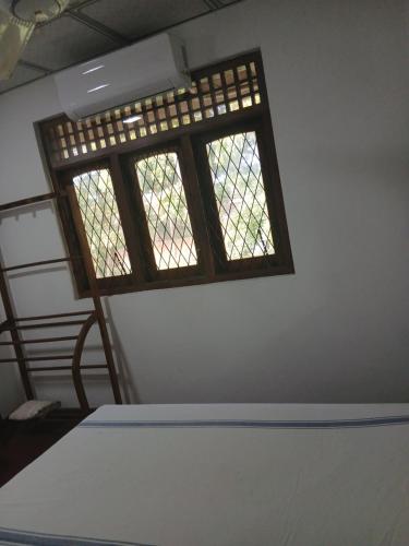 a room with a bed and a window at Nilwala River Corner Villa in Matara
