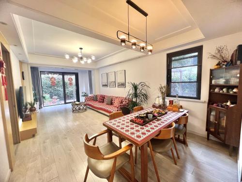 a living room with a table and a couch at Coco's Nest in Shanghai