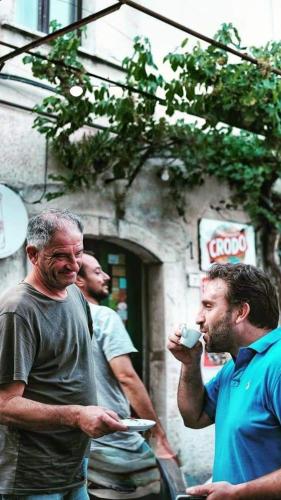 a group of men standing outside of a building at Locanda dell'Angelo in Valle dellʼAngelo
