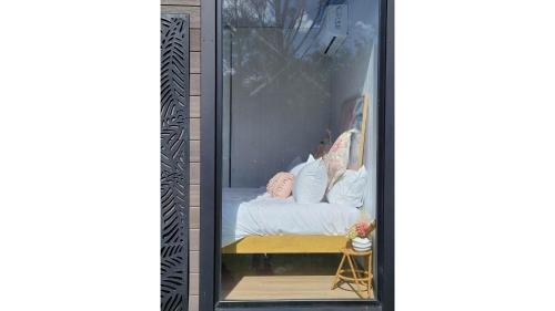 a room with a bed in a glass case at Deloraine Tiny Retreat by Tiny Away in Whangarei