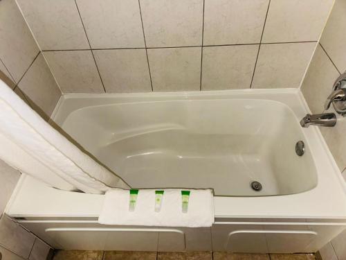 a white bath tub in a small bathroom at Silver crest lodge in Grande Prairie