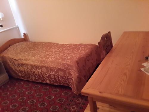 a couch in a room with a wooden table at Islambek Hotel & Travel in Khiva