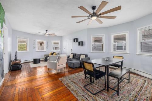a living room with a table and a ceiling fan at Stylish 5 bedroom near Downtown Providence & Providence College in Providence