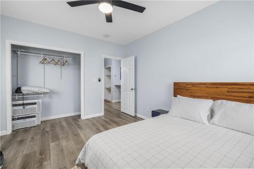 a bedroom with a white bed and a ceiling fan at Stylish 3 bedroom near Downtown Providence & Providence College in Providence