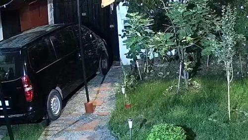 a black car parked next to a house with trees at Villa Dar Lghzal Summer Promo Airport Pick-Up & Private Dining in Heart of Rabat in Rabat