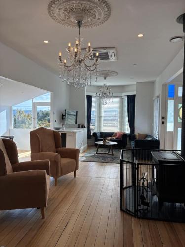 a living room with a chandelier and a living room at Forest Rd Haven with Tamar River Views in Inveresk