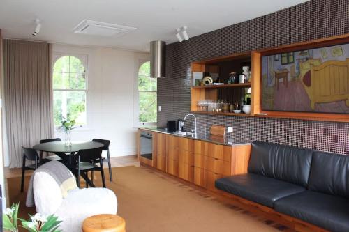 a living room with a couch and a table at Le Salon Luxury City Apartment with Free Parking in Launceston