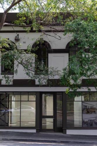 a building with glass windows and a door at Le Salon Luxury City Apartment with Free Parking in Launceston