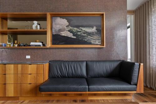 a black leather couch in a living room at Le Salon Luxury City Apartment with Free Parking in Launceston