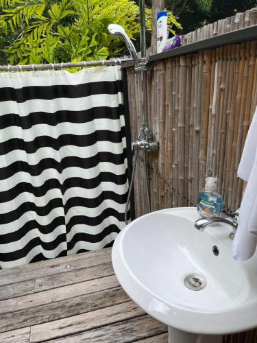a bathroom with a sink and a towel at Safari tent with private pool close to Manuel Antonio in Matapalo