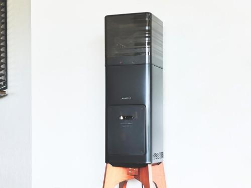 a person is holding a black and gray appliance at Cairns House by SANA in Tateyama