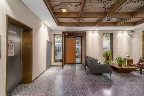 an office hallway with a door and a chair at Weiting Hotel Shanghai North Sichuan Road Hongkou Football Stadium Subway Station Branch in Shanghai