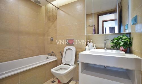 a bathroom with a toilet and a sink and a tub at Vinhomes Metropolis Hanoi - CitiHome in Hanoi