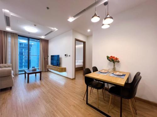 a living room with a table and chairs and a living room at Vinhomes Metropolis Hanoi - CitiHome in Hanoi