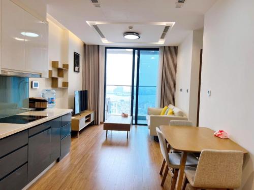 a kitchen and living room with a table and a couch at Vinhomes Metropolis Hanoi - CitiHome in Hanoi
