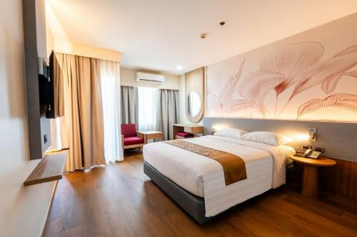 a hotel room with a large bed and a television at Asia Airport Hotel in Bangkok