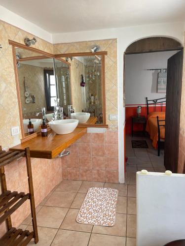 a bathroom with two sinks and a large mirror at Canne al vento in Quartu SantʼElena