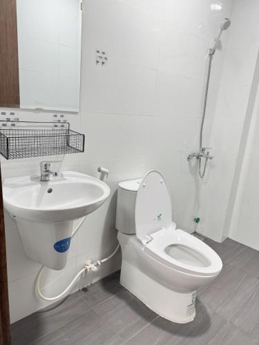 a bathroom with a toilet and a sink at Live like a local Homestay in Ấp Tư Tây