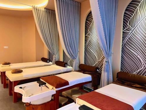 a hospital room with four beds and a sink at The Manor Villas Da Lat in Xuan An