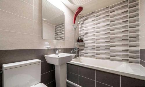 a bathroom with a sink and a tub and a toilet at Nowon Luxe Hotel in Seoul