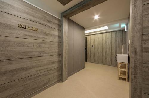 a hallway with wood paneled walls and a door at Gwangju Yeogijoa Hotel in Gwangju