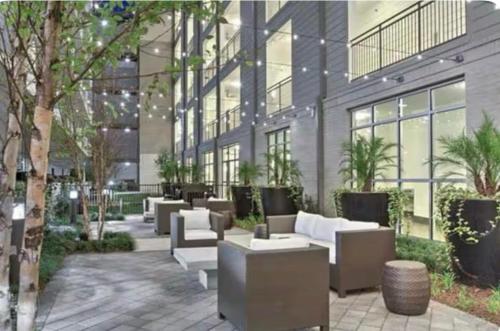 a building with couches and tables in a courtyard at Downtown Houston Retreat with Free Parking in Houston