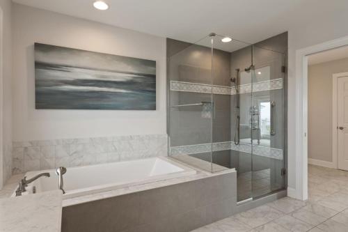 a large bathroom with a tub and a shower at 3025 - Who's On First in Southern Shores