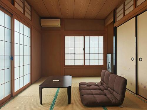 a living room with a couch and a table at Traditional 2-Story Japanese Home Near Narita in Shisui