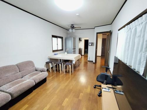a living room with a couch and a table at Traditional 2-Story Japanese Home Near Narita in Shisui