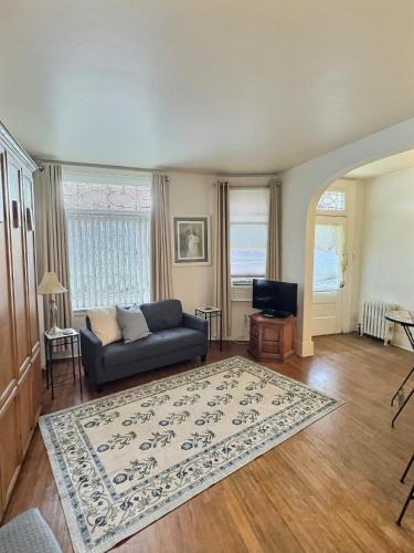 a living room with a couch and a rug at Historic LaSalle Downtown in Fort Wayne