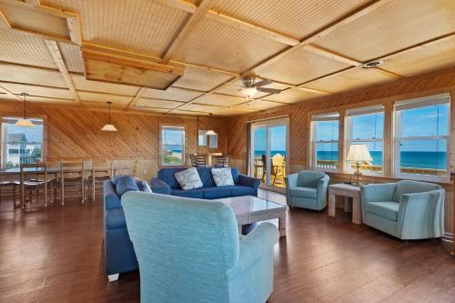 a living room with blue couches and a table at 7143 - Geri's Place #4 in Wanchese