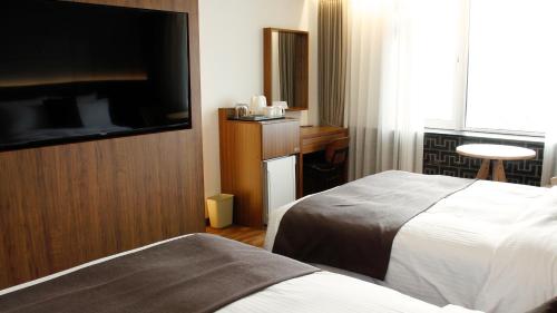 Postel nebo postele na pokoji v ubytování Commodore Hotel Gyeongju