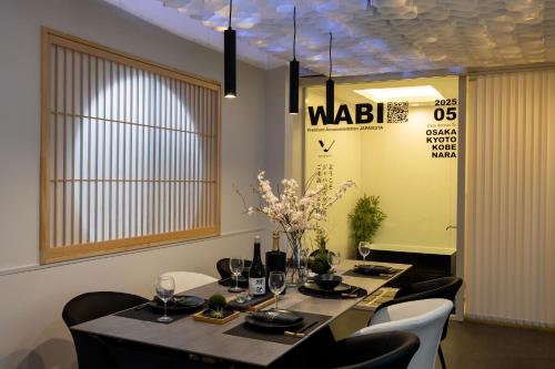 a dining room with a long table and chairs at JAPAVISTA Wabi in Osaka