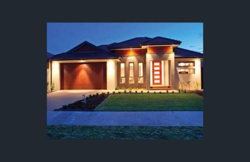 a large house with a lawn in front of it at The Mount Martha Hideaway in Mount Martha