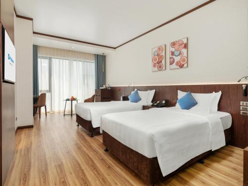 Ένα ή περισσότερα κρεβάτια σε δωμάτιο στο Wyndham Legend Halong
