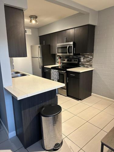a kitchen with brown cabinets and a counter top at 2 Bed 1 Bath Quiet Apartment Central Location in Phoenix in Phoenix