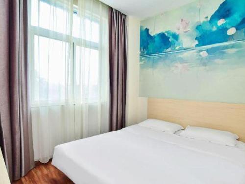 a bedroom with two beds and a window at Super 8 Hotel Jinan Railway Station Square in Jinan