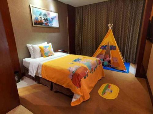 a bedroom with a bed with a play tent at Jinhua World Trade Hotel in Jinhua