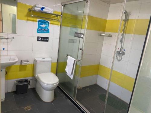 a bathroom with a shower and a toilet and a sink at 7 Days Inn Jinan Changqing Jingshi West Road Center in Jinan