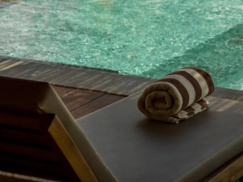 a shell sitting on a table next to a pool at Anna Villas by Sumba-Beach in Memboro