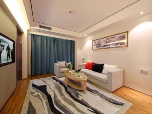 a living room with a couch and a table at East Queen Hotel (Xi'an Beimen Metro Station) in Xi'an