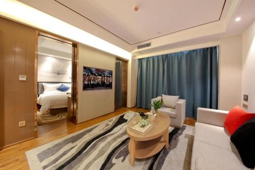 a living room with a couch and a table at East Queen Hotel (Xi'an Beimen Metro Station) in Xi'an