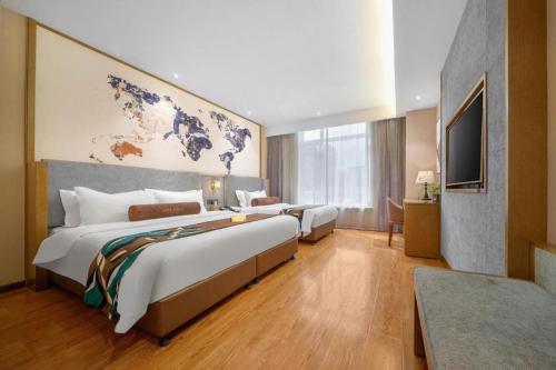 a hotel room with two beds and a flat screen tv at James Joyce Coffetel·Changchun Railway Station in Changchun