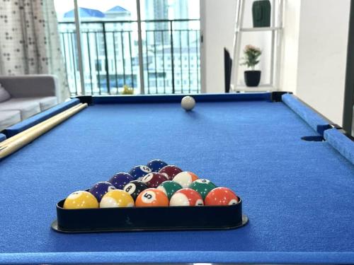 a pool table with balls in the middle of it at JOVIAL Modern Cozy Suite `Metropol BM BandarPerda in Bukit Mertajam