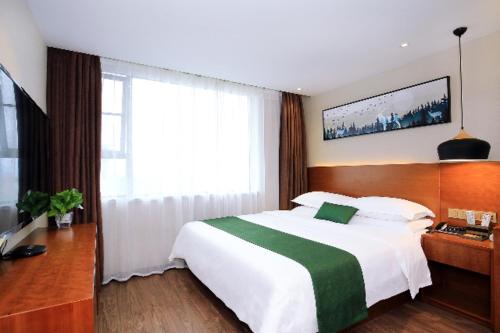 a bedroom with a large white bed and a window at Immersing Hotel Guilin Two Rivers and Four Lakes Dongxi Alley in Guilin