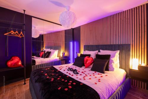 une chambre avec un grand lit avec des fleurs rouges dessus dans l'établissement Love Room 91 avec Jacuzzi Privatif 30 min de Paris pour nuit insolite, à Longjumeau